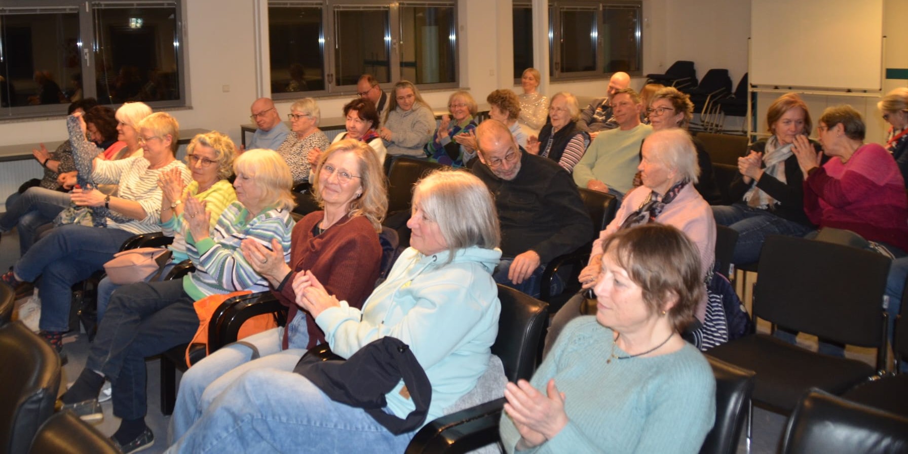 BesucherInnen sitzen im Saal und hören der Lesung zu